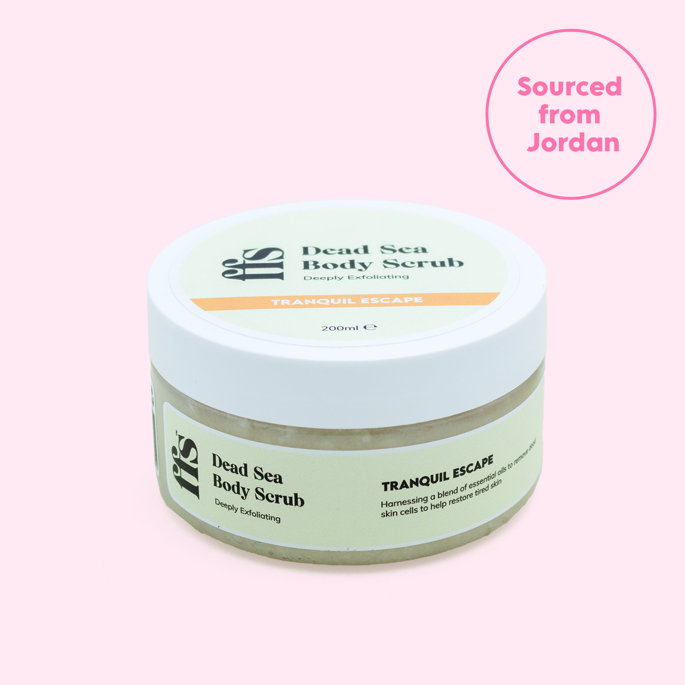 FFS Tranquil Escape Dead Sea Body Scrub 200ml jar — angled view showing lid and label on a pink background